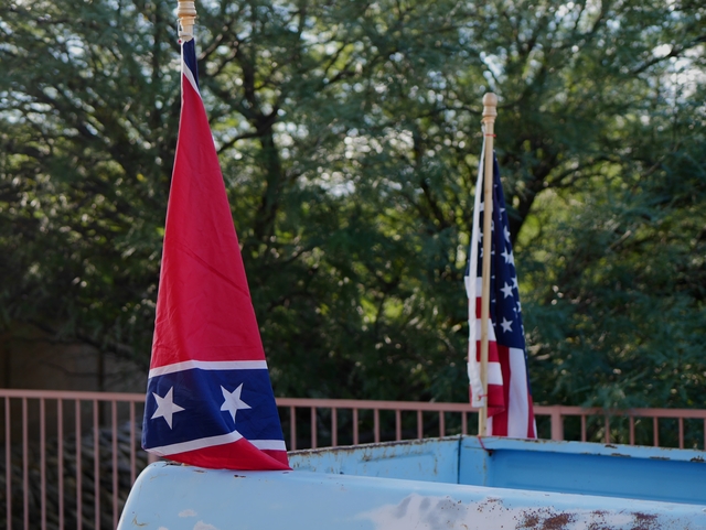 Photo of American and Confederate flags on a pickup truck by Charlie Bertsch
