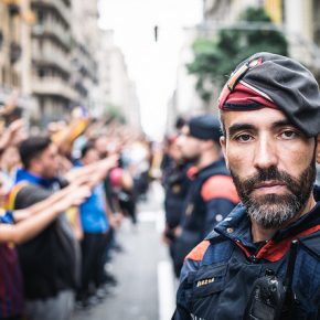 Catalan police officer and protestors. Barcelona, October 2017.